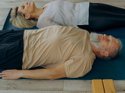 A pair of wooden yoga blocks on a wooden floor
