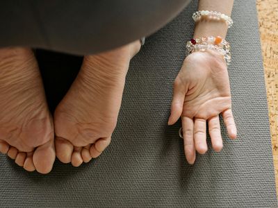 Close-up of feet on a yoga mat during stretching